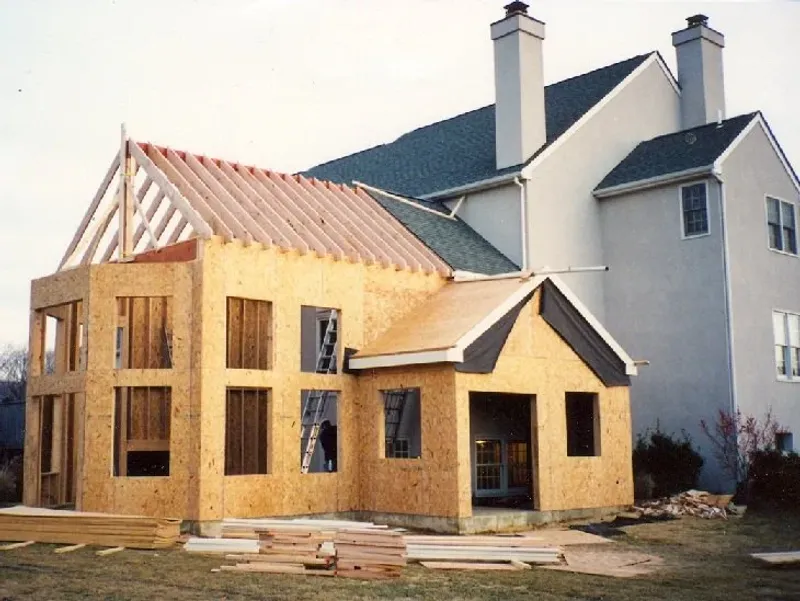 Home addition with stone fireplace and architectural details