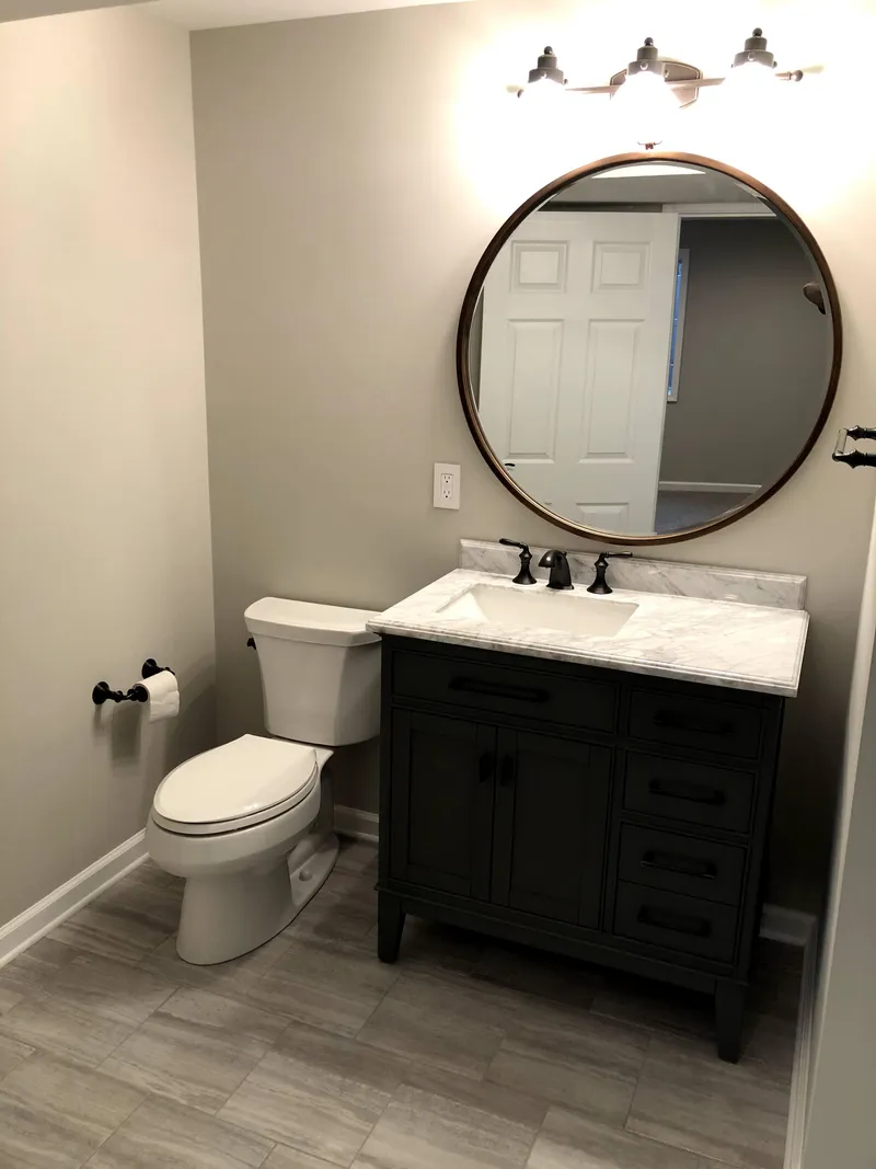 Luxury bathroom renovation with stone finishes and custom vanity